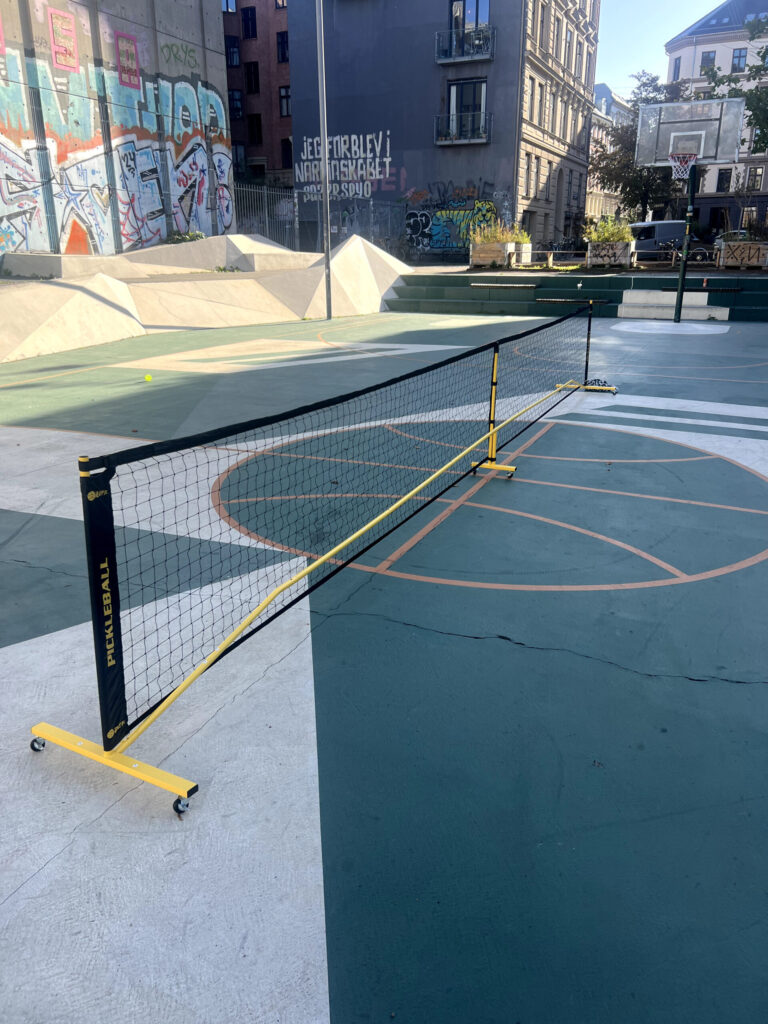 Fostoy portable pickleball net set up at full 22 ft width on an outdoor basketball court