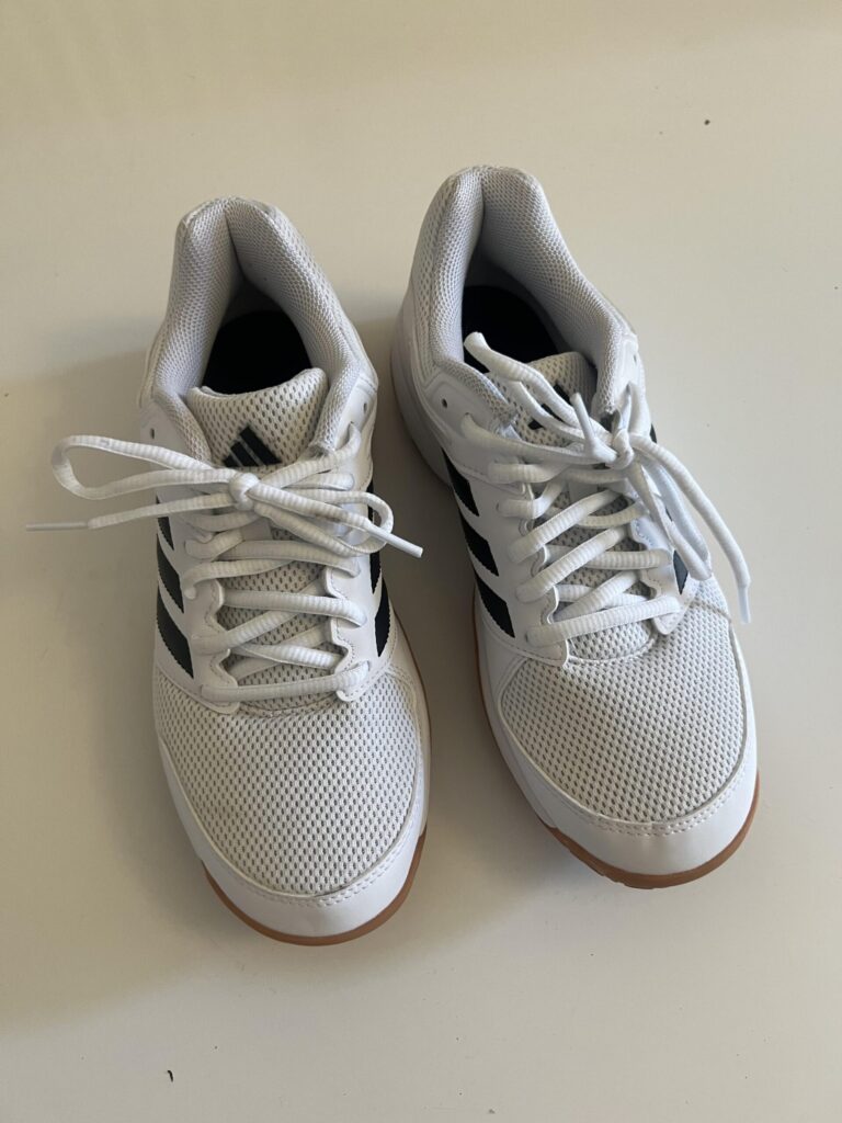 Pair of white black and gum adidas Speedcourt indoor shoes viewed from above