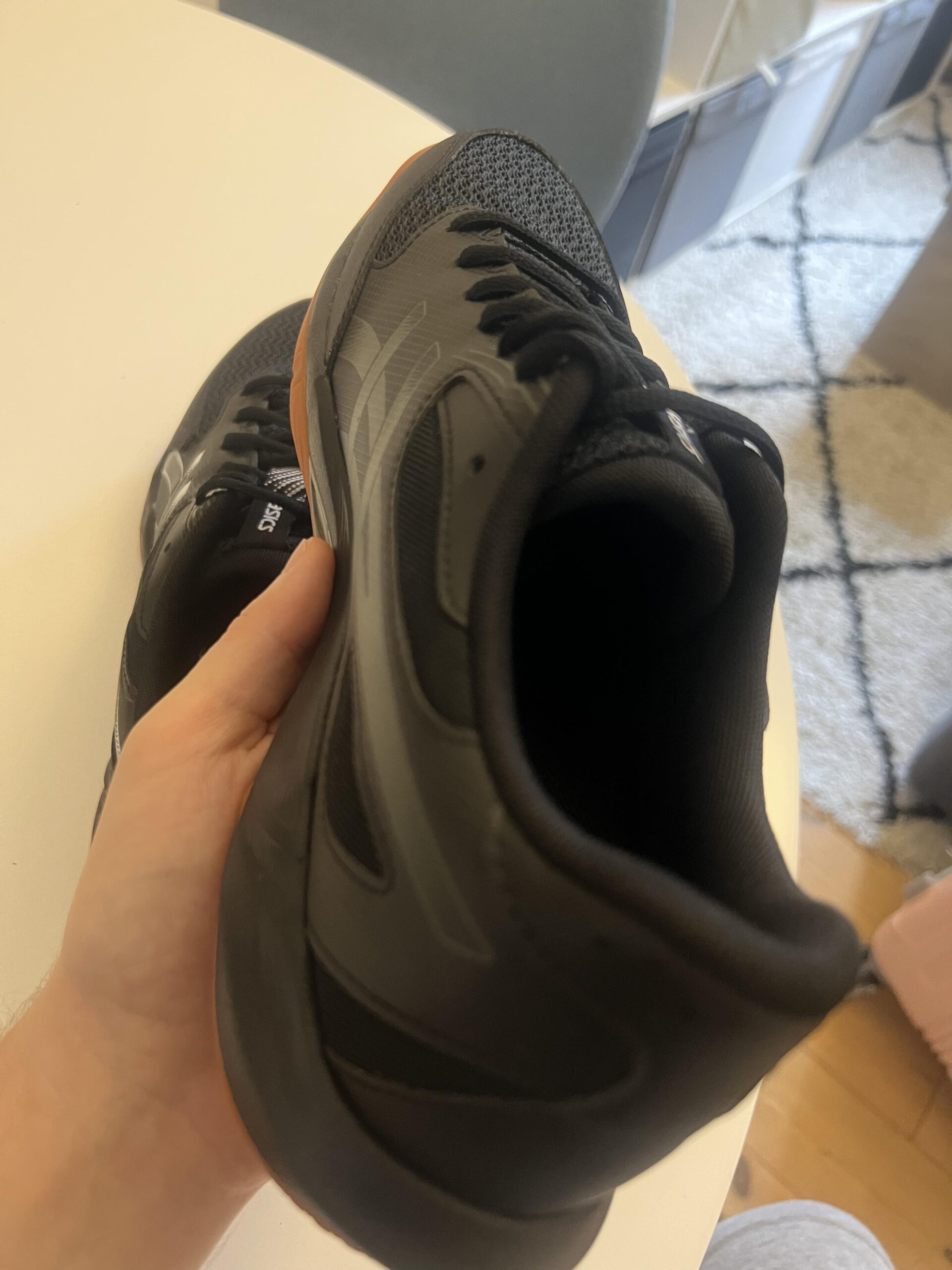 Lateral side of a black and gunmetal ASICS GEL-ROCKET 12 shoe