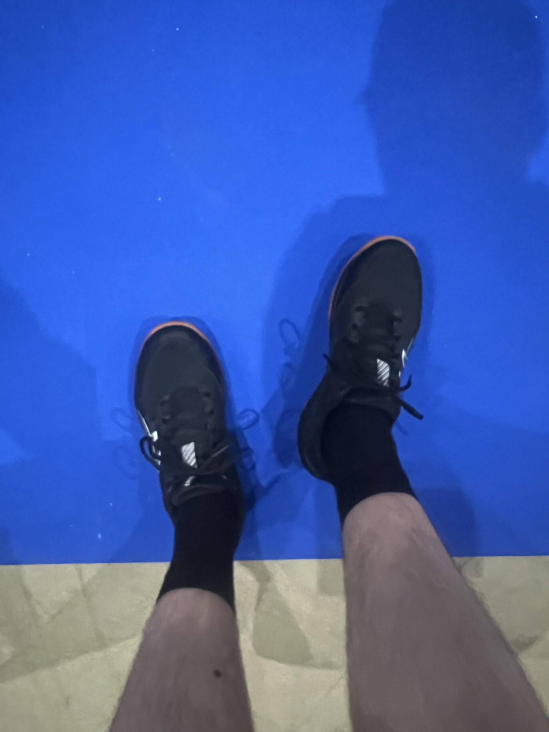 Reviewer wearing ASICS GEL-ROCKET 12 shoes on a blue indoor pickleball court