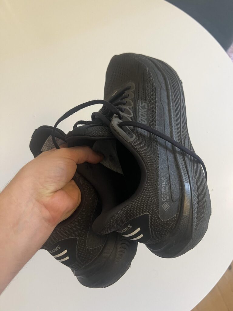 Black Brooks Ghost 17 GTX shoes showing the side profile, heel and GORE-TEX branding after regular use