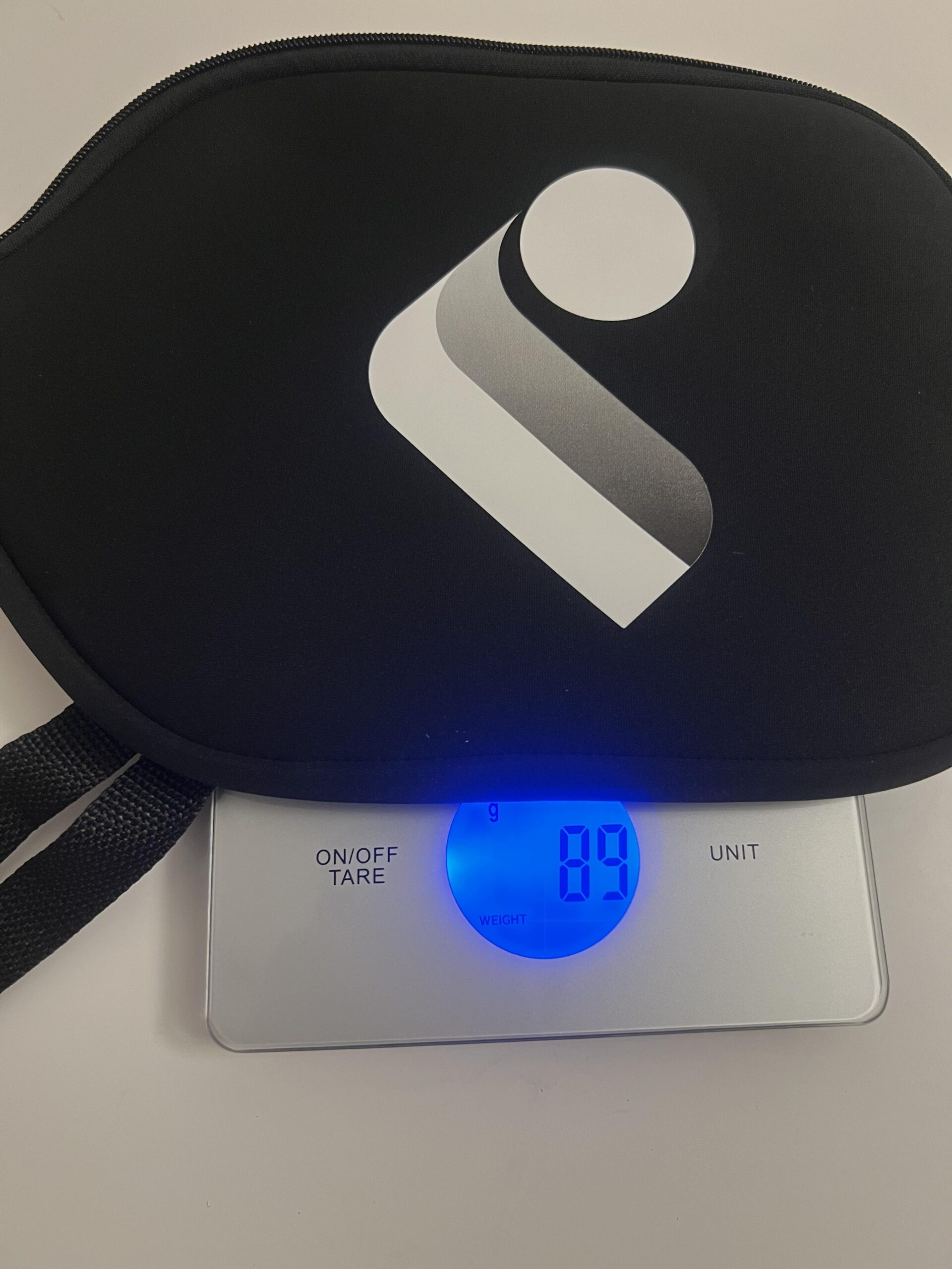 JOJOLEMON paddle cover on digital scale displaying 89 grams