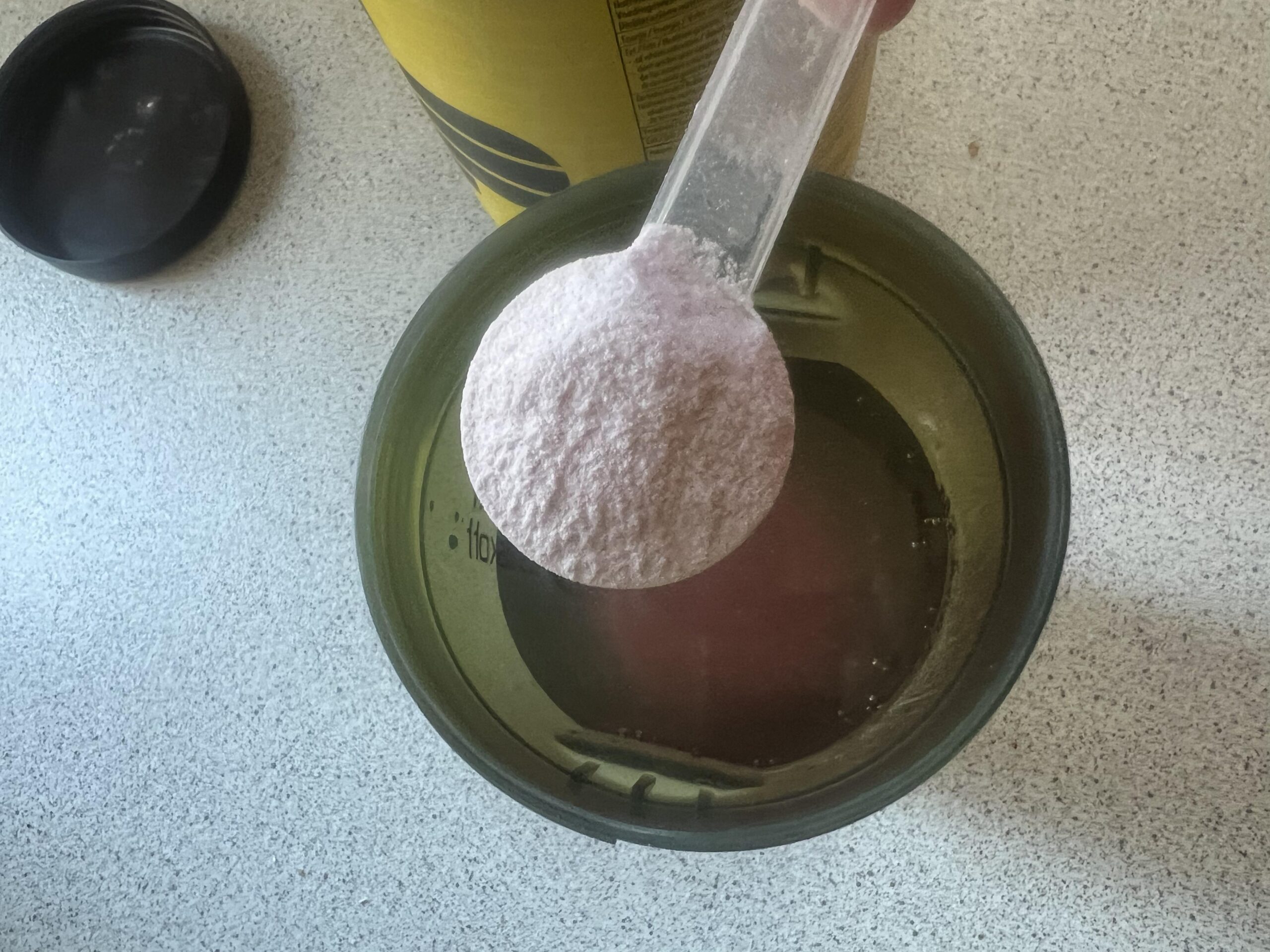 PowerBar Isoactive Red Fruit powder in the measuring scoop I use before pickleball