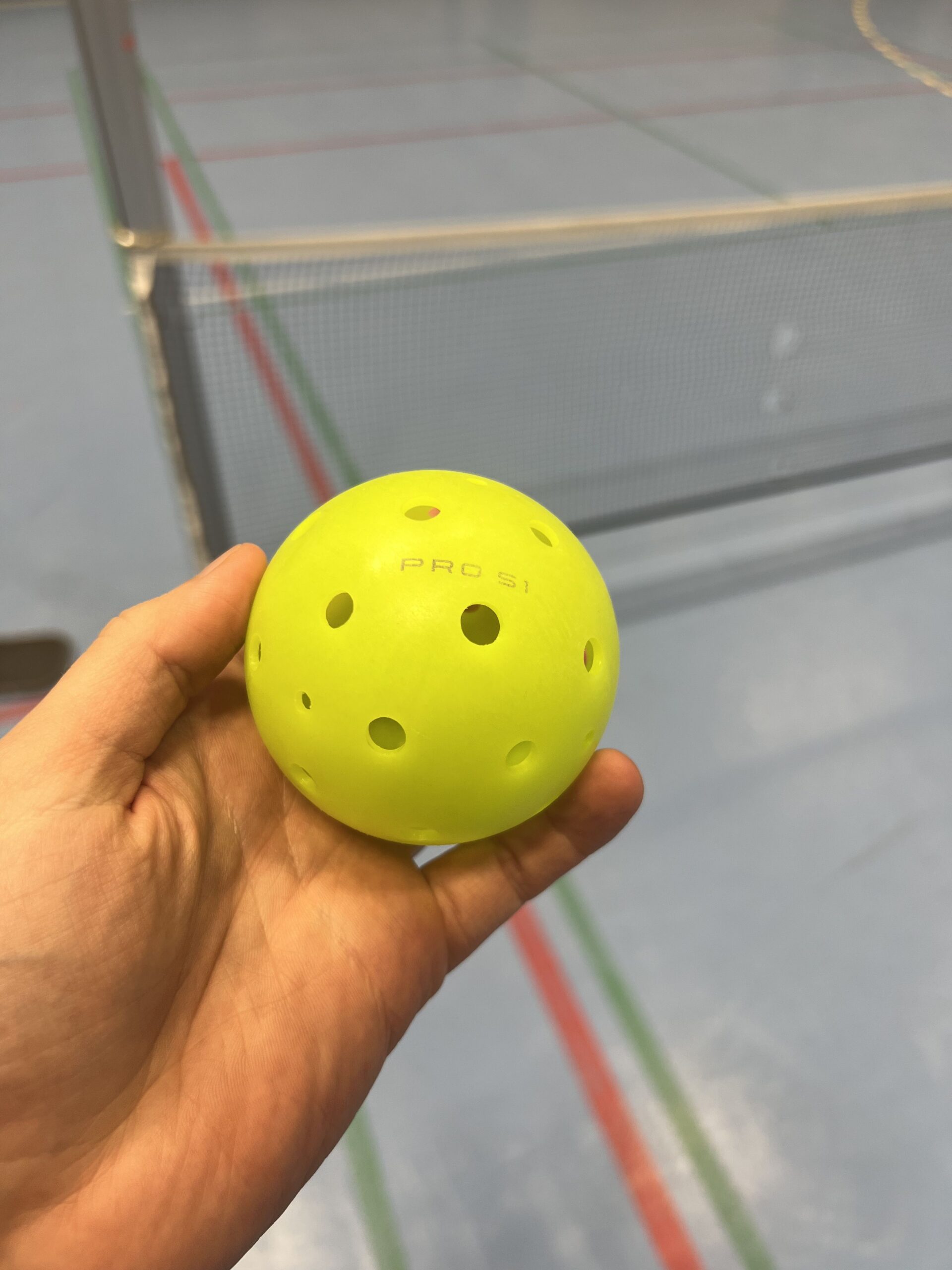 Lime Selkirk Pro S1 pickleball held on the outdoor court where I used it