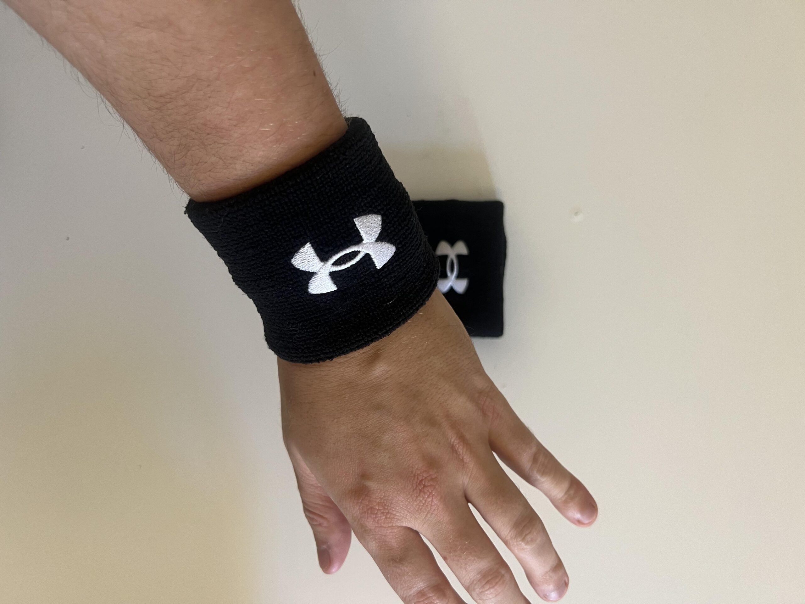 Black Under Armour 3-inch Performance Wristband worn during pickleball use
