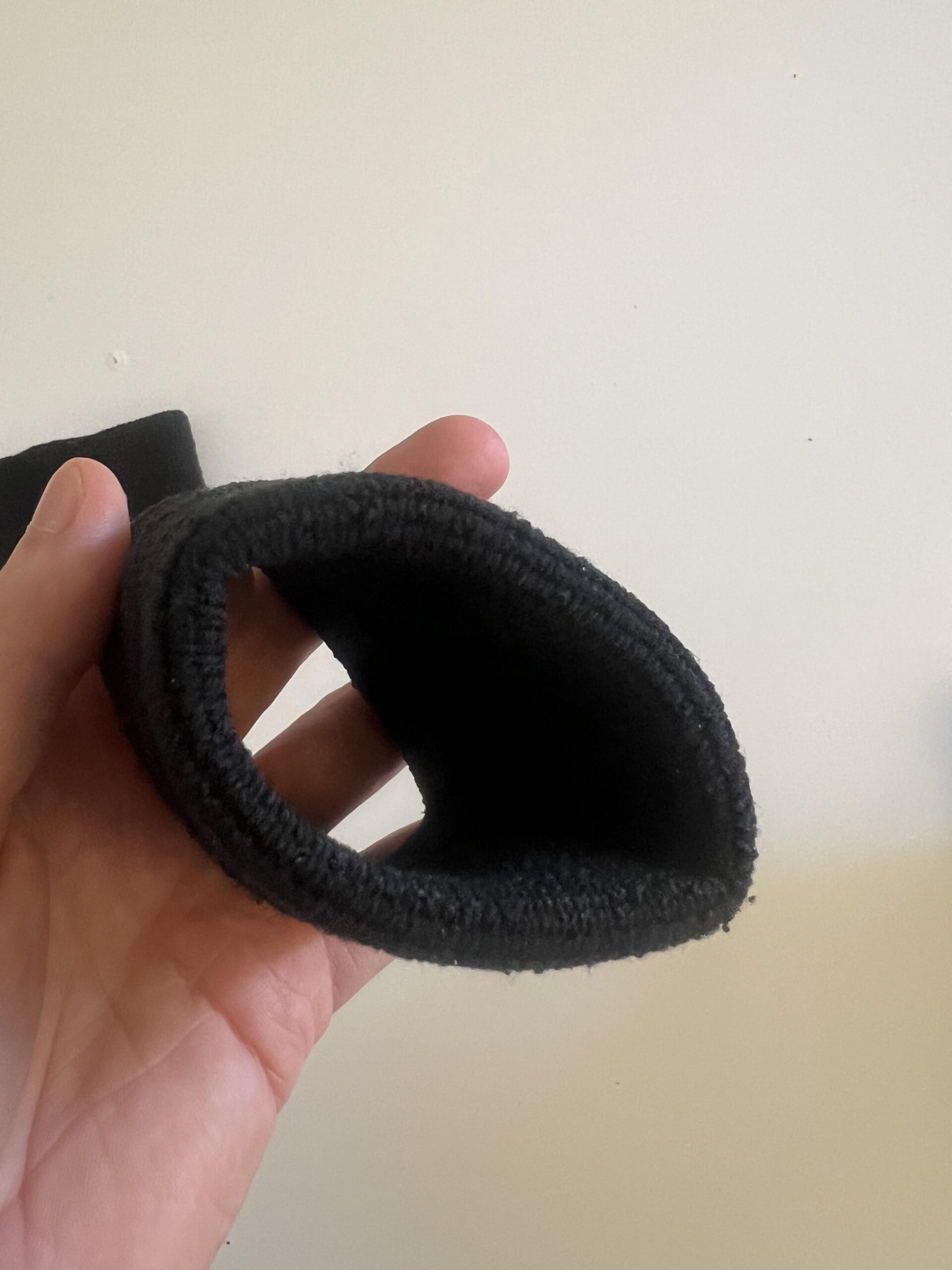 Inside opening and elastic construction of a black Under Armour 3-inch Performance Wristband