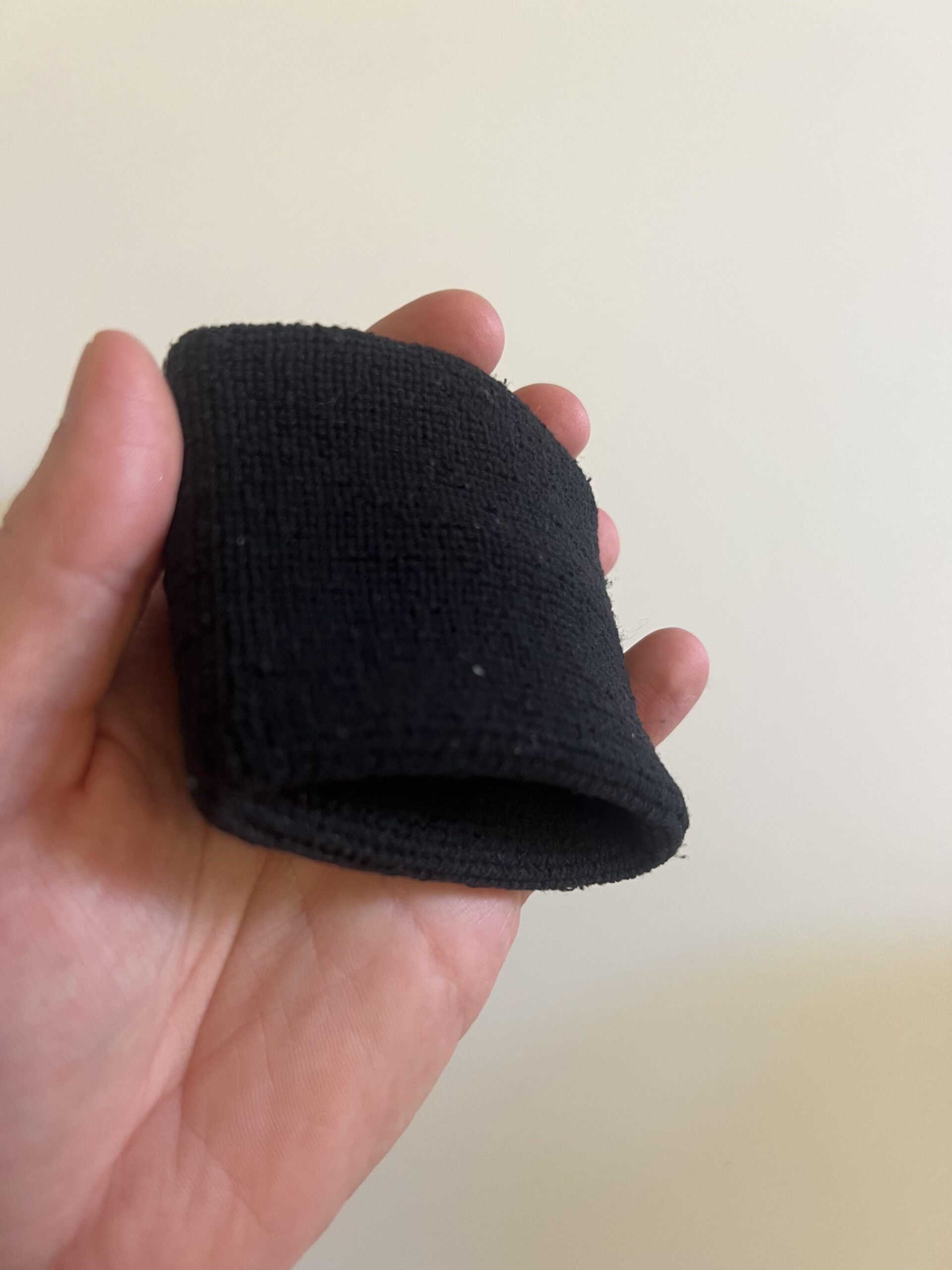 Close-up of the black fabric and edge of an Under Armour 3-inch Performance Wristband