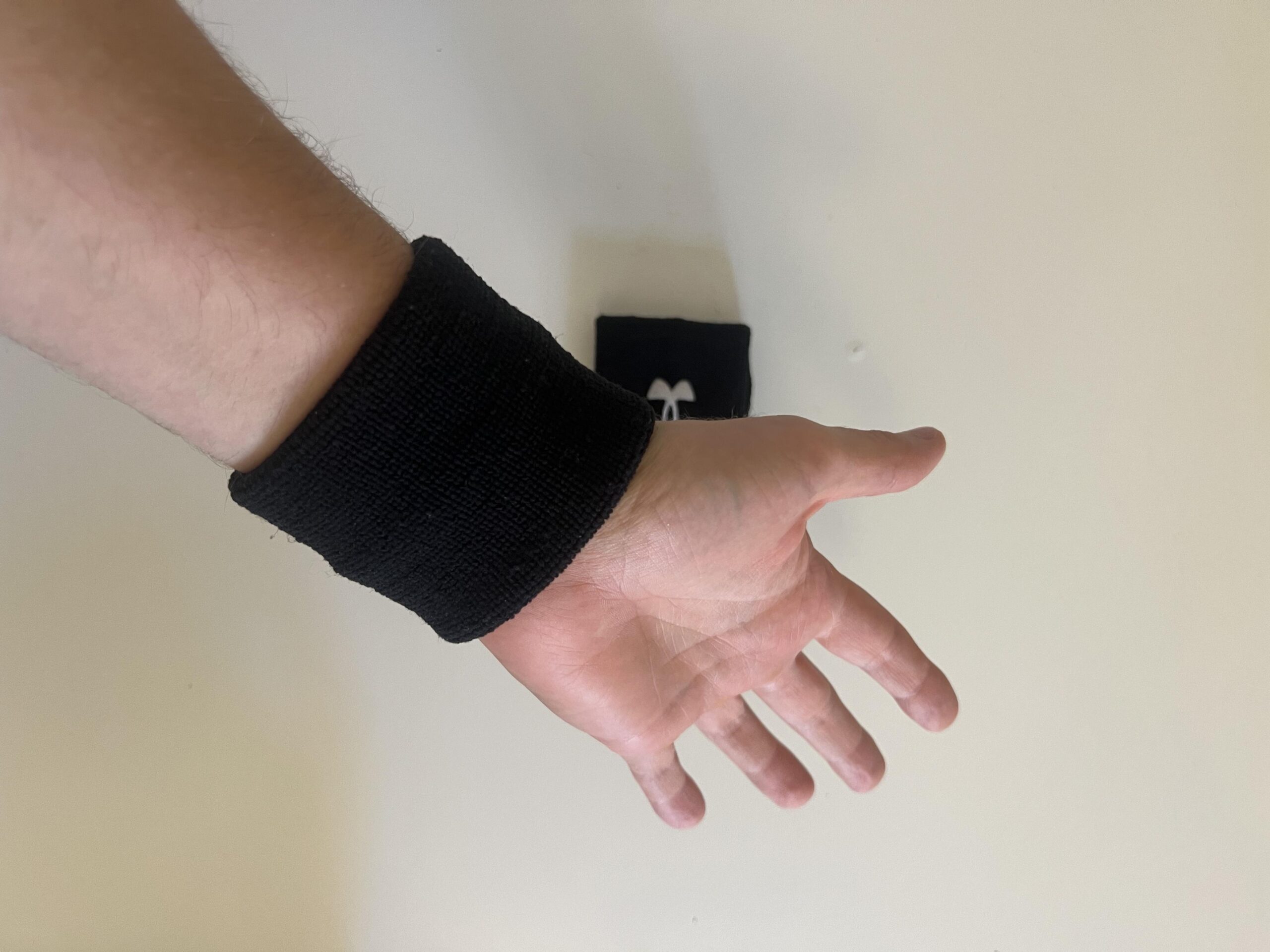 Under Armour 3-inch Performance Wristband shown fitted around the inner wrist