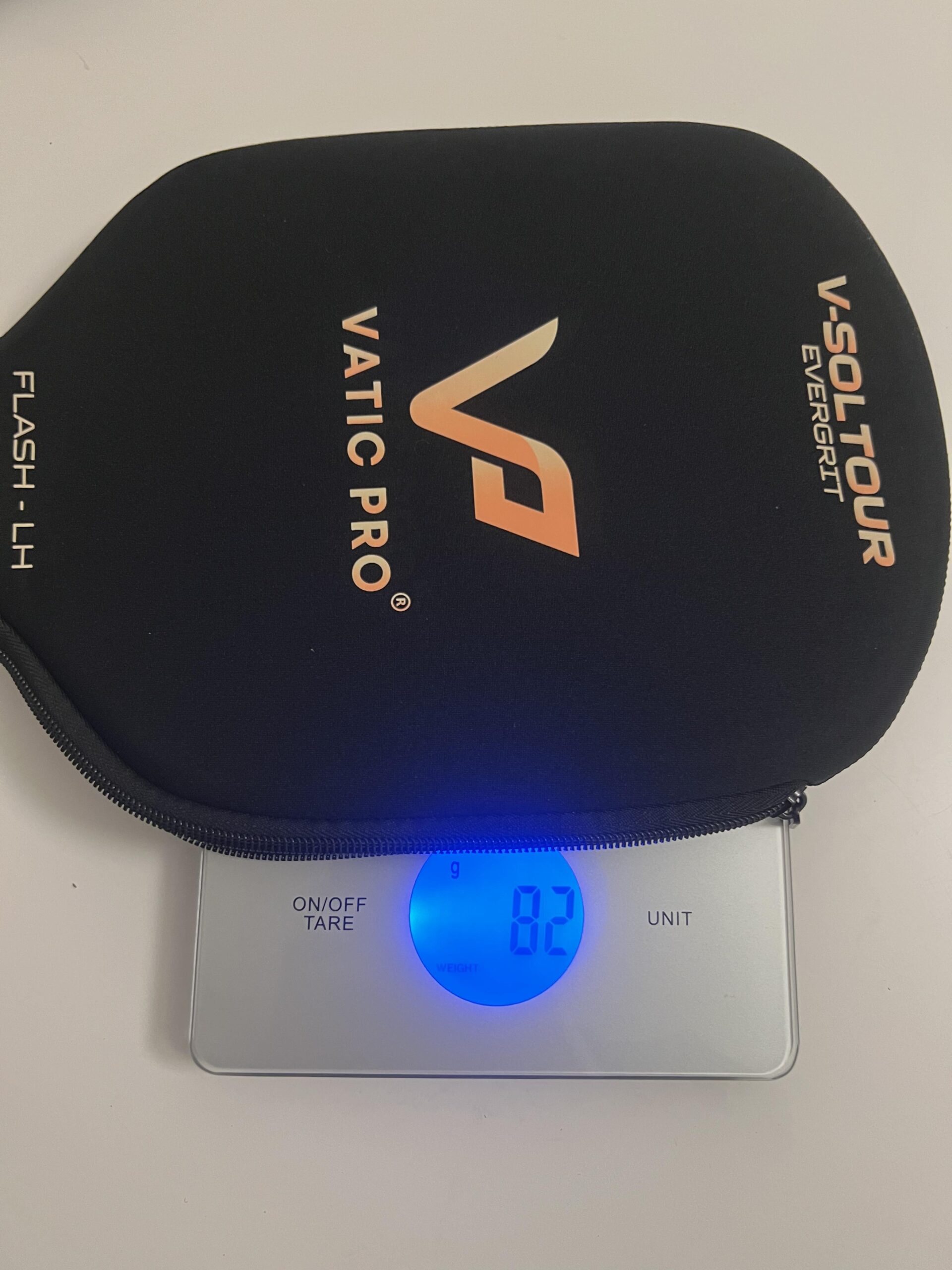 Vatic Pro Flash LH paddle cover on digital scale displaying 82 grams